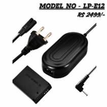 "LP-E12 Dummy Battery AC Power Adapter Kit for Canon cameras, showing the DR-E12 DC Coupler, the power brick, and the AC wall plug cable. Model No: LP-E12, Price: ₹2199/-."