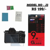"9H Tempered Glass Screen Protector (Model No - J3) for a Nikon mirrorless camera, priced at RS 199/-. The image shows the boxed product highlighting 9H Strong Hardness, Bubble-Free, explosion-proof, and eye-protection features, along with the included cleaning accessories and the protector overlaid on a camera's rear screen."