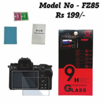 9H Tempered Glass screen protector kit for camera, Model FZ85, priced at Rs 199. Shows the glass placed over a camera screen, packaging box highlighting 9H hardness, and cleaning accessories (wipes and dust absorber).