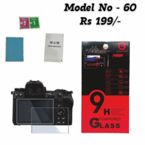A product image for a camera screen protector, labeled "Model No - 60, Rs 199/-." The image displays the clear tempered glass protector piece overlaid on the screen of a black mirrorless or DSLR camera. Next to it is the retail box, which is red and black, emphasizing "9H Tempered Glass" and listing features like Strong Hardness, Bubble Free, Ultra-Slim Thickness, Delicate Touch, Explosion Proof, and Eye Protection. Installation accessories, including a blue cleaning cloth, two wet/dry wipes (labeled 1 and 2), and a dust-absorber sticker, are also visible.