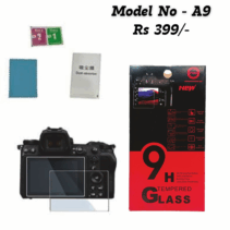 A product image showing a camera screen protector kit, labeled "Model No - A9" and priced at "Rs 399/-". The kit includes two clear tempered glass protectors shown over a modern mirrorless camera (possibly a Nikon Z series), a cleaning cloth, wet/dry wipes, and a dust absorber sticker. The main retail box is red and black, emphasizing "9H Tempered GLASS" with features listed like 9H Hardness, Smudge proof, Explosion proof, and Bubble Free installation.