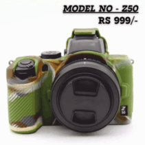 A Nikon Z50 mirrorless camera covered in a custom silicone protective case featuring a green, brown, and tan military camouflage pattern. The lens cap is on, and the camera is shown against a white background. Text overlay reads: "MODEL NO - Z50 RS 999/-".