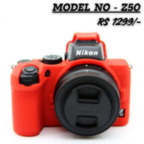 Red silicone protective cover for the Nikon Z50 mirrorless camera, shown mounted on the camera body. The text overlay reads "MODEL NO - Z50" and "RS 1299/-". The cover protects the camera body while leaving the lens and controls accessible.
