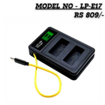 "A black rectangular dual-slot battery charger with a green LCD screen showing charging status. A bright yellow USB cable is attached to the side. Text at the top reads Model No LP-E17, Price RS 809."