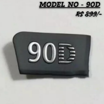 Close-up of a Canon EOS 90D replacement logo nameplate featuring silver "90D" lettering on a black durable badge for camera body repair.