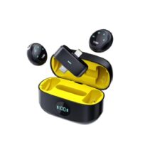 K31 Pro Wireless Lavalier Microphone system featuring two circular clip-on transmitters, a dual-connector receiver for iPhone and Android, and a black digital charging case displayed against a piano keyboard background.