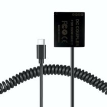 Close-up of a USB-C to DMW-DCC11 DC Coupler dummy battery showing the Type-C input connector and FCC/CE safety certifications.